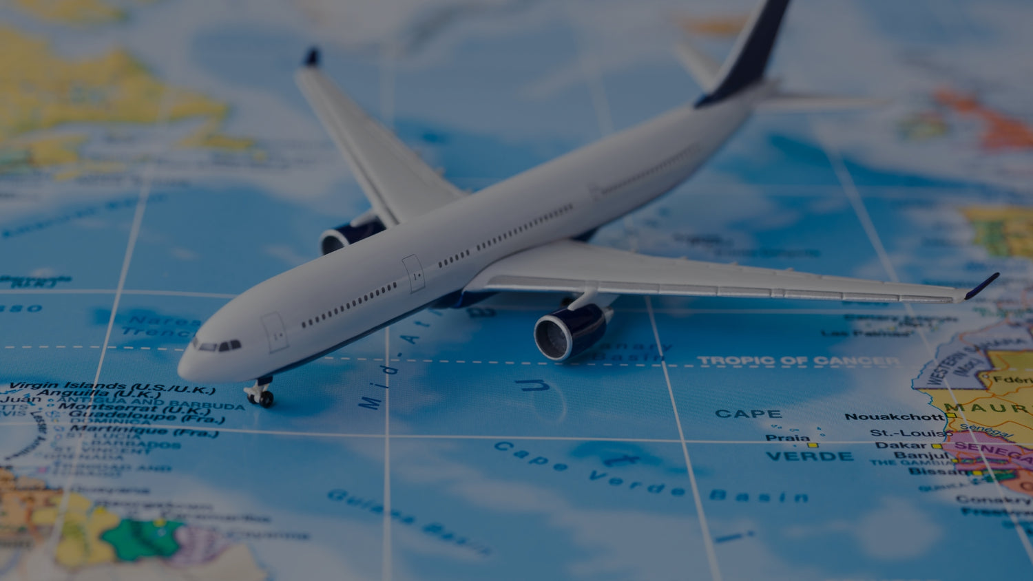 Model airplane on a world map